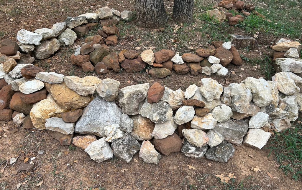 Demonstration of how to build a rock garden using two rings of stacked rocks